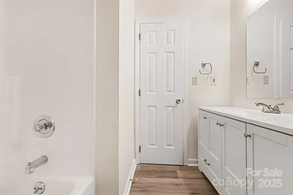 a bathroom with a sink a mirror and a shower