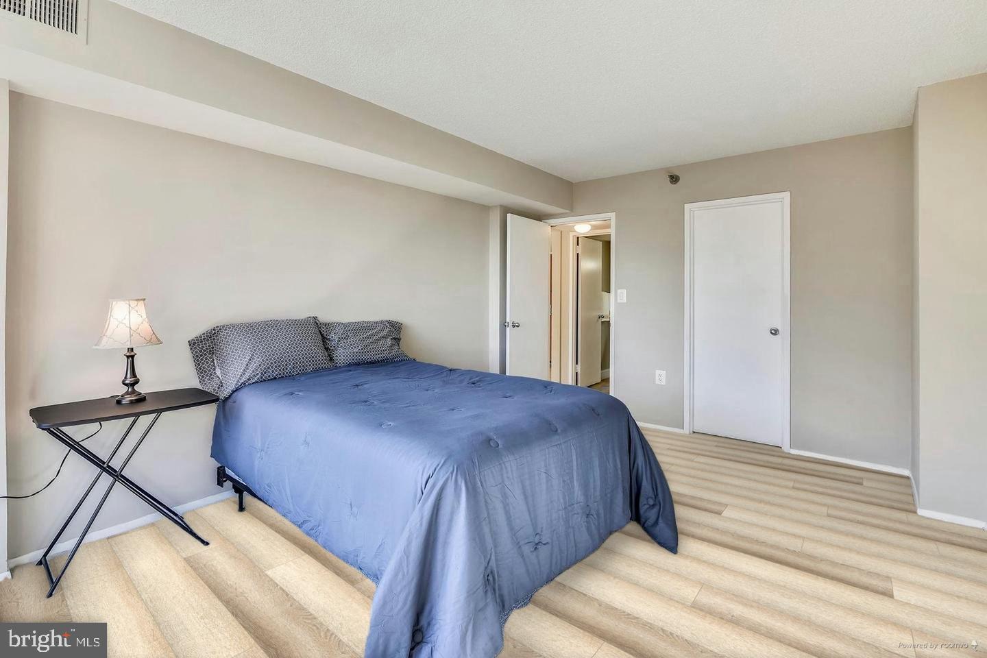 1808 Old Meadow Road, Unit 910 McLean, VA 22102 - Photo 11 of 28 Bedroom with laminate flooring. AI generated pic.