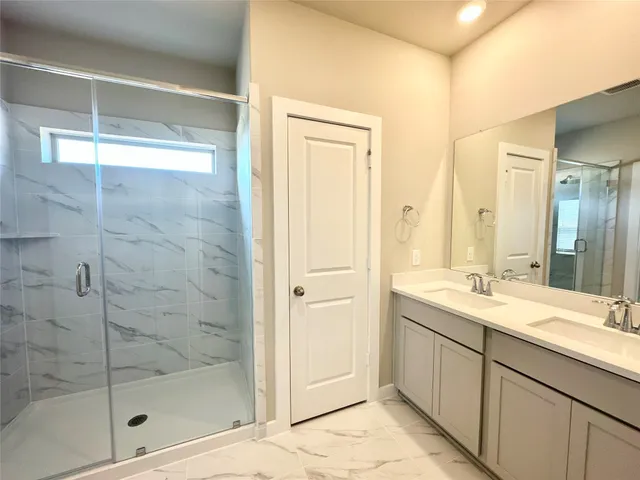 a bathroom with a sink a mirror and a shower