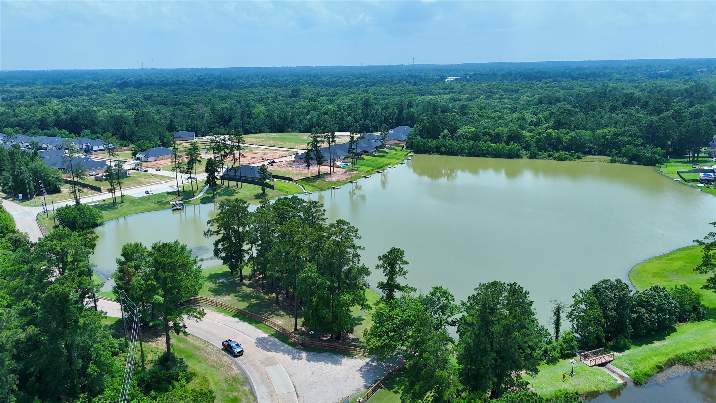 12324 Ridge Top Drive Conroe, TX 77304 - Photo 18 of 25 an aerial view of a house with a garden and lake view