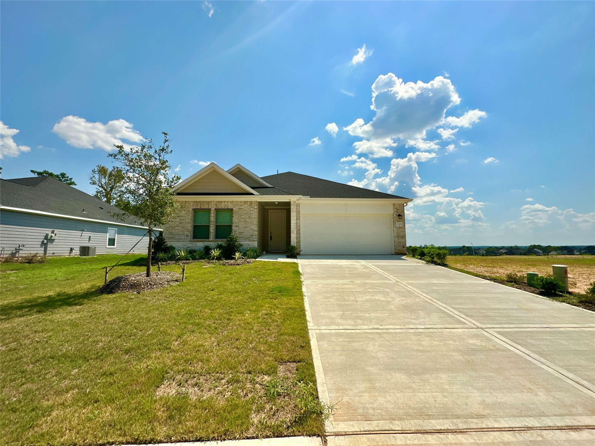 12324 Ridge Top Drive Conroe, TX 77304 - Photo 2 of 25 a front view of house with yard space and swimming pool