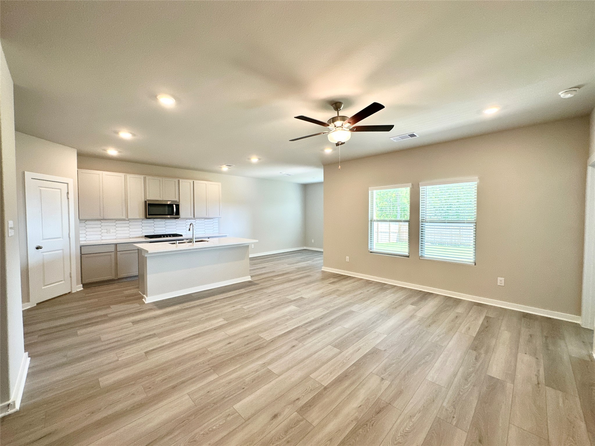 12324 Ridge Top Drive Conroe, TX 77304 - Photo 25 of 25 a large white kitchen with a large window a oven and white cabinets