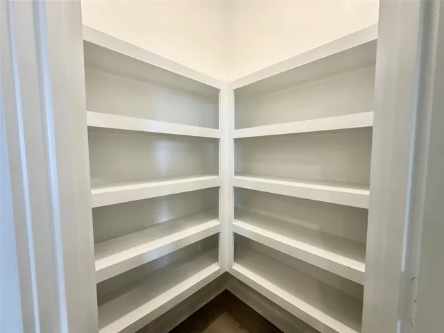 a kitchen with white cabinets appliances and sink