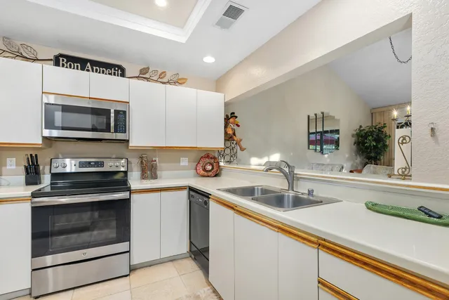 a kitchen with a sink and steel appliances