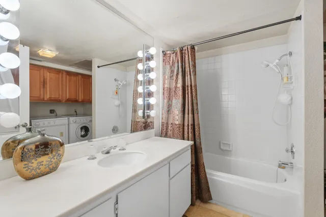 a bathroom with a tub sink and mirror