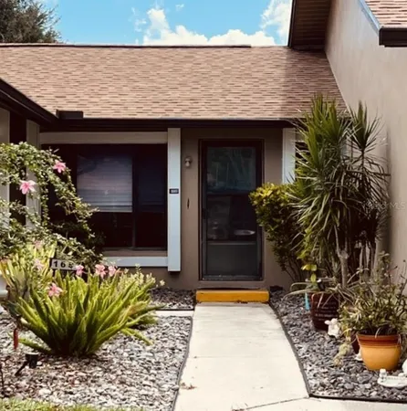a view of house with potted plants