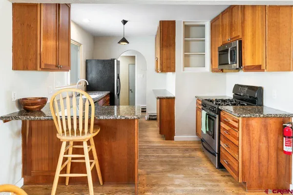 a kitchen with granite countertop a sink and a stove top oven