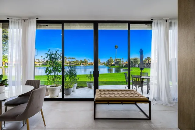 a view of a two room with wooden floor and outdoor seating