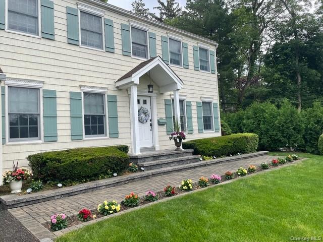 145 Shore Road Manhasset, NY 11030 - Photo 3 of 23 a front view of house with yard and green space