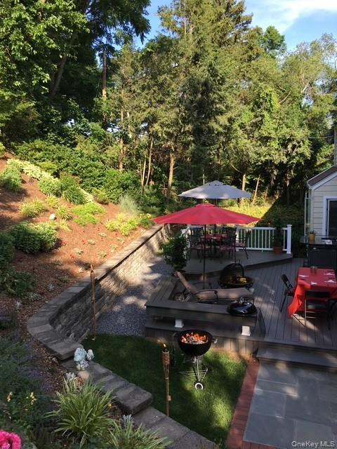 145 Shore Road Manhasset, NY 11030 - Photo 6 of 23 a view of a house with a yard patio and a garden