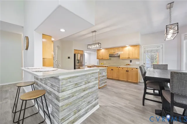 a large kitchen with a table and chairs
