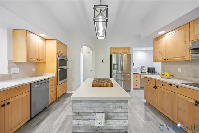a kitchen with cabinets window and stainless steel appliances