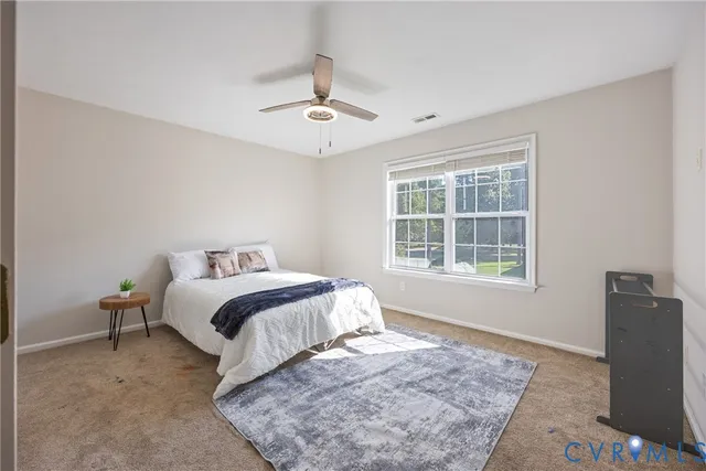 a bedroom with a large bed and a window