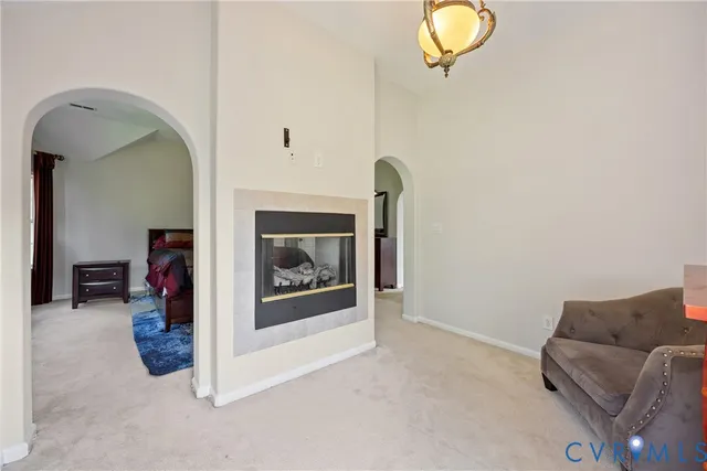 a living room with furniture and a mirror