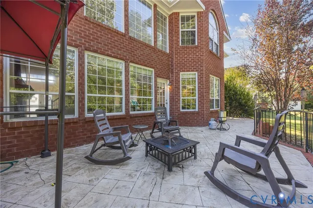 a view of a patio with couple of chairs and a fountain