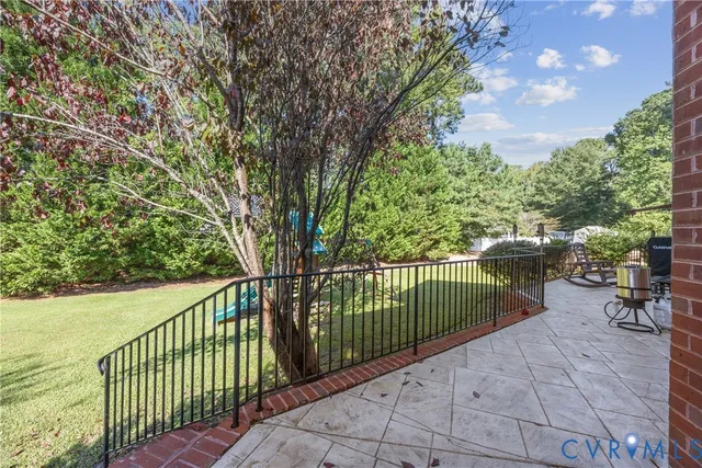 a view of a deck with a large window and chairs