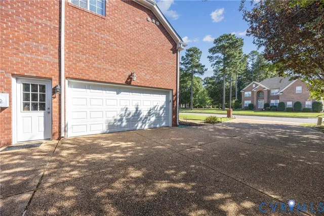 a view of a house with a yard and garage