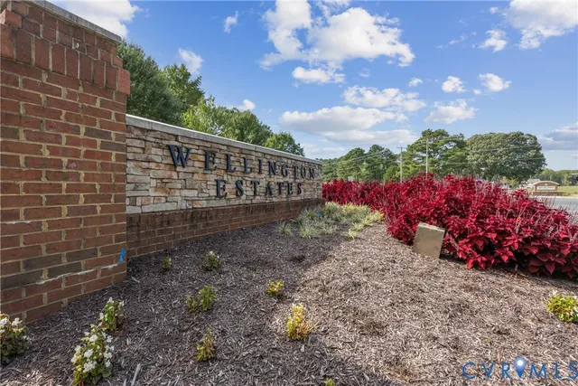 a view of a yard with plants and wooden fence