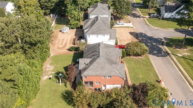 an aerial view of a house with swimming pool garden and patio