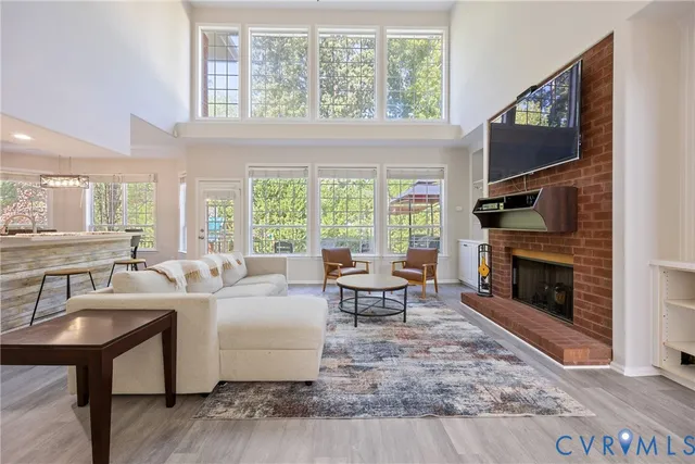 a living room with fireplace furniture and a flat screen tv