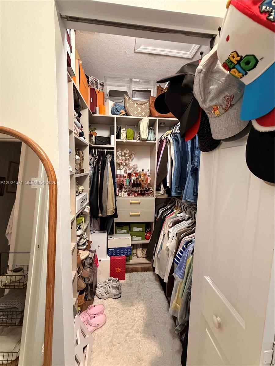 2116 Northeast 38th Road, Unit 2116 Homestead, FL 33033 - Photo 14 of 31 a view of walk in closet with clothes and shoes