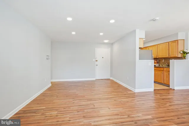 a view of empty room with wooden floor