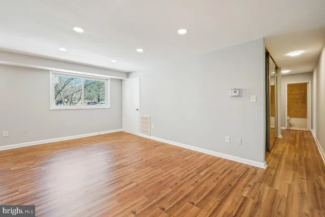 wooden floor in an empty room with a window