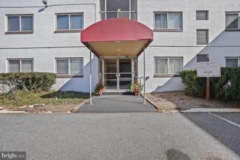 a view of a house with a patio and a yard