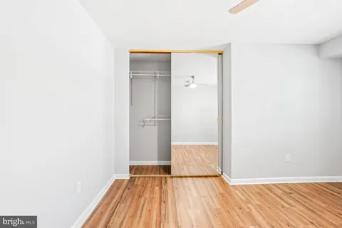 a view of a room with wooden floor and a sink