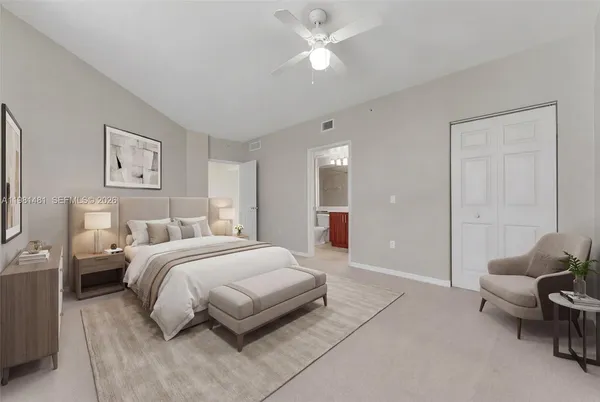 a spacious bedroom with a bed and a chandelier