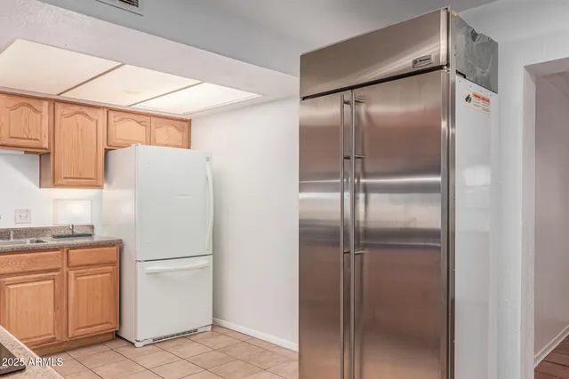 a view of an empty room and a chandelier fan