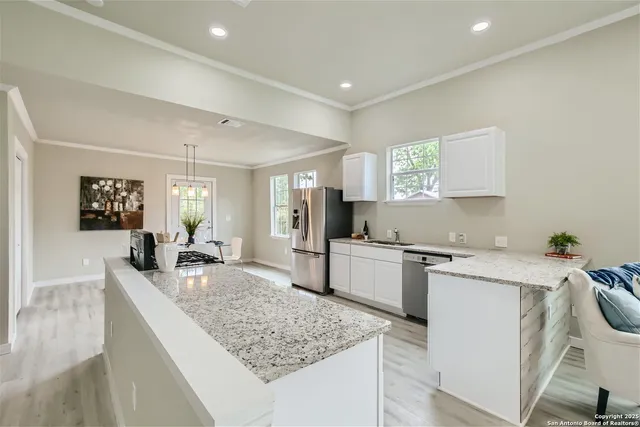 a kitchen with a sink stove and refrigerator