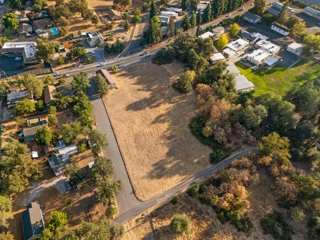 an aerial view of residential houses with outdoor space