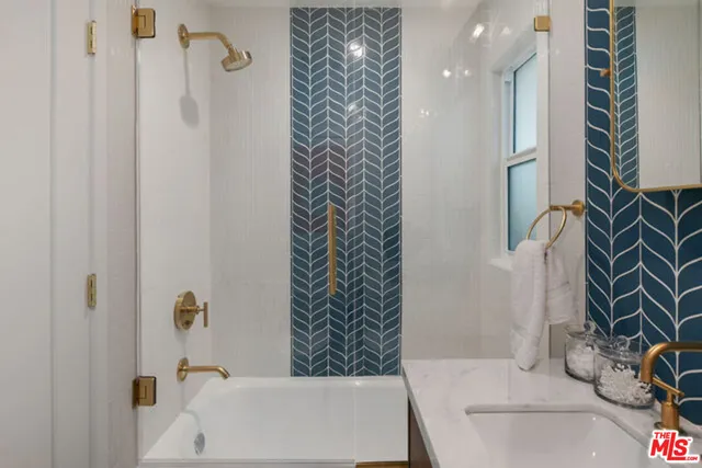 a bathroom with a bathtub and shower