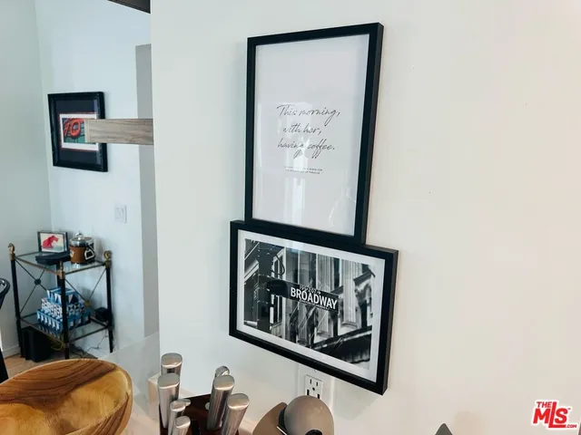 a bathroom with a painting on the wall and a wall