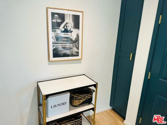 a living room with a toilet and a refrigerator