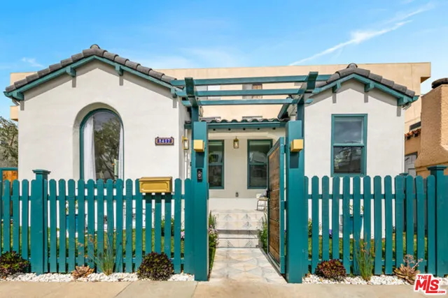 a view of a white house with large windows