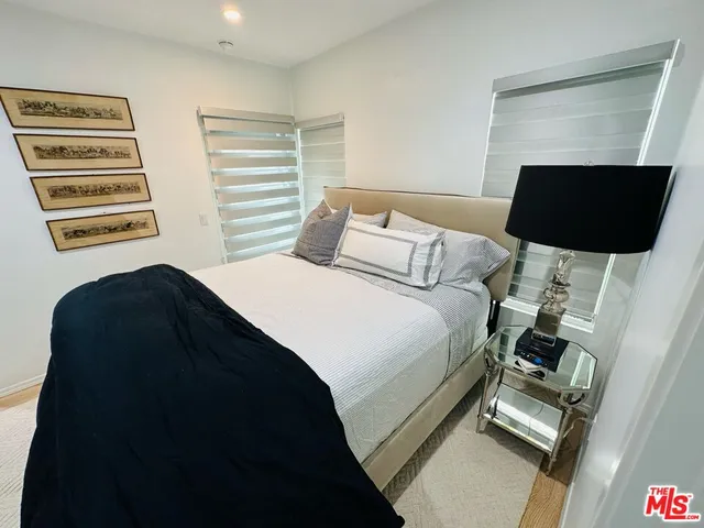 a bedroom with a bed and a television