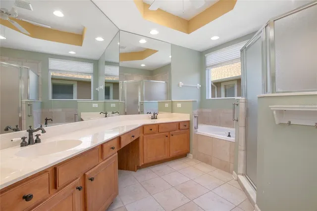 a spacious bathroom with a granite countertop sink mirror and bathtub