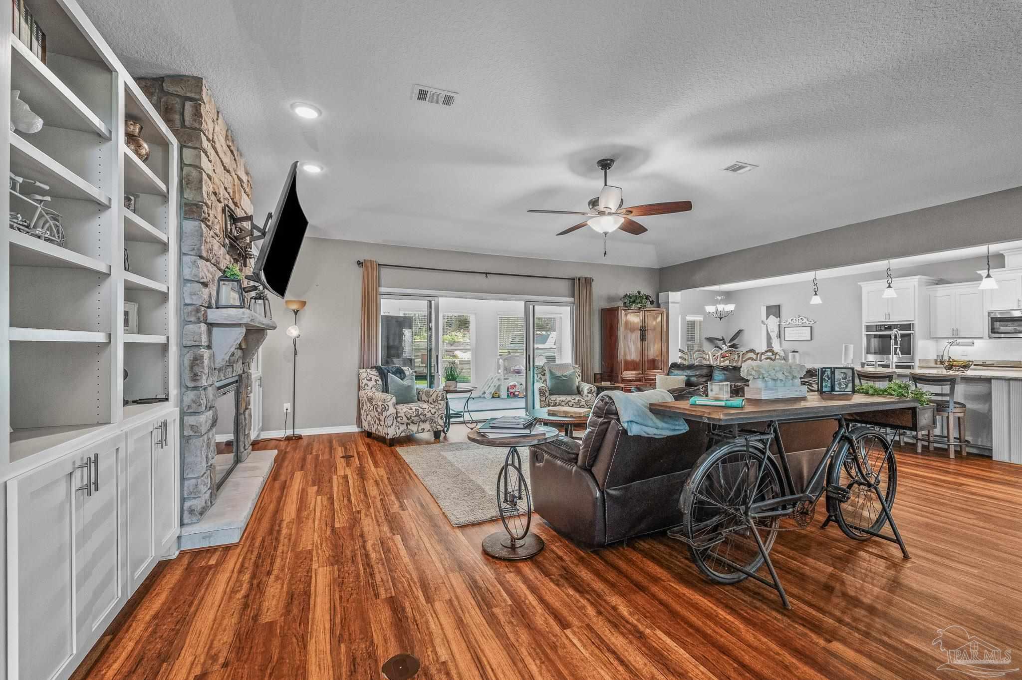 10443 Tam O Shanter Road Pensacola, FL 32514 - Photo 11 of 57 a living room with lots of furniture and a chandelier