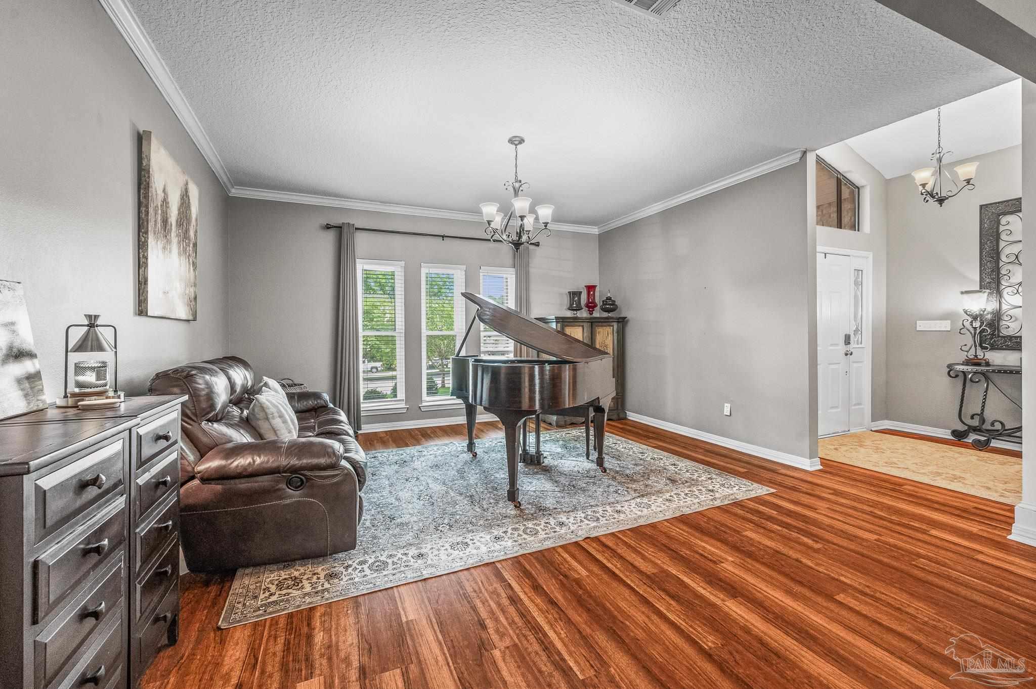 10443 Tam O Shanter Road Pensacola, FL 32514 - Photo 13 of 57 a living room with furniture and a chandelier
