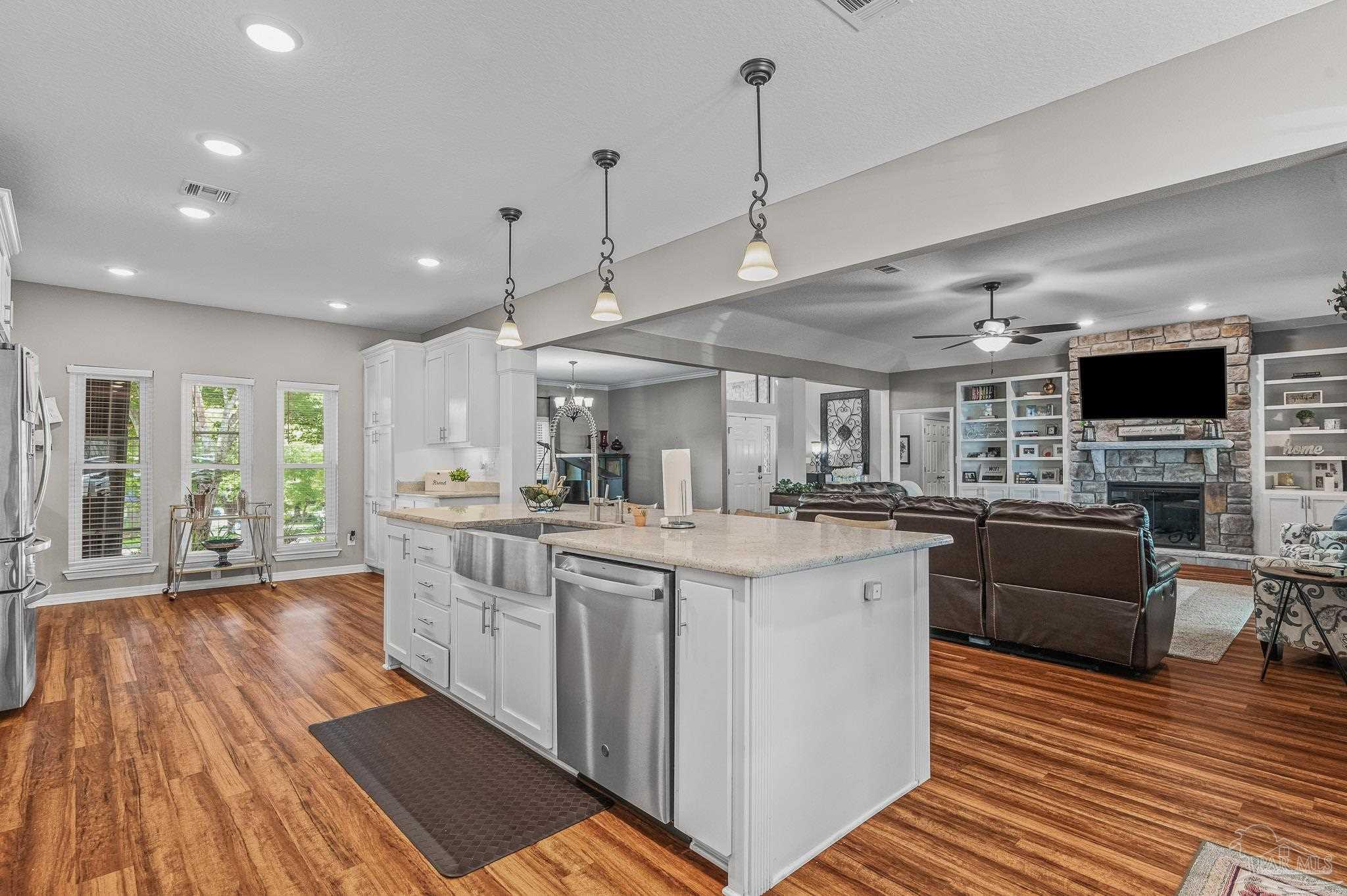 10443 Tam O Shanter Road Pensacola, FL 32514 - Photo 16 of 57 a large kitchen with stainless steel appliances granite countertop a large center island and a wooden floors