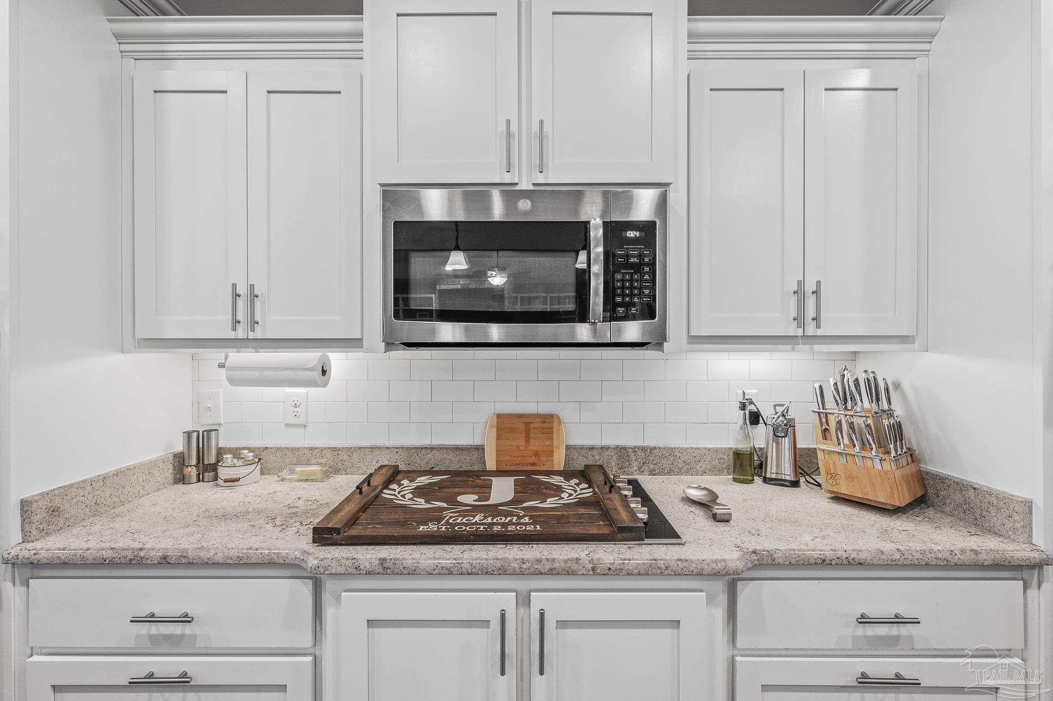 10443 Tam O Shanter Road Pensacola, FL 32514 - Photo 18 of 57 a kitchen with granite countertop white cabinets and a white stove