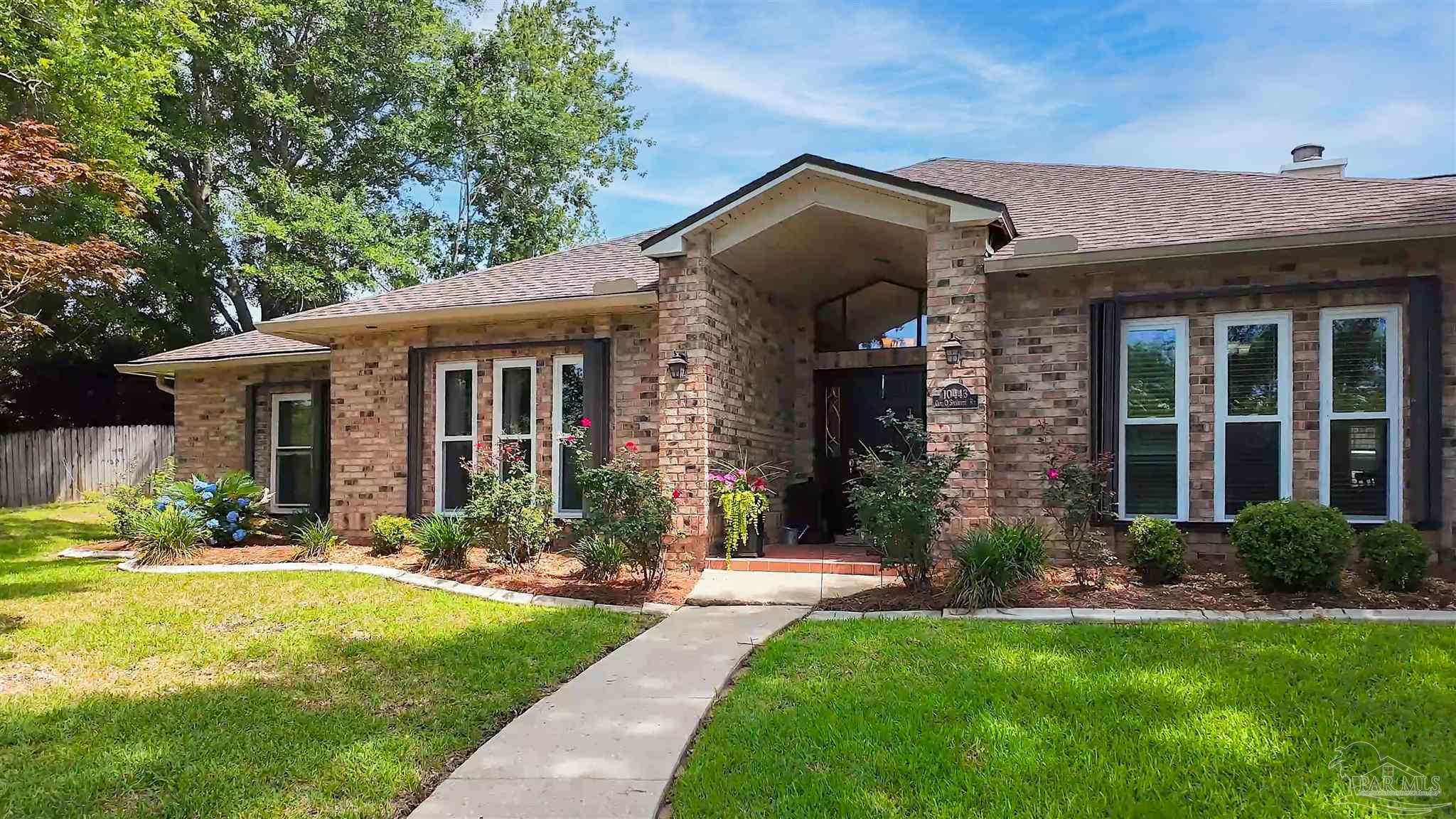 10443 Tam O Shanter Road Pensacola, FL 32514 - Photo 2 of 57 a front view of a house with a yard