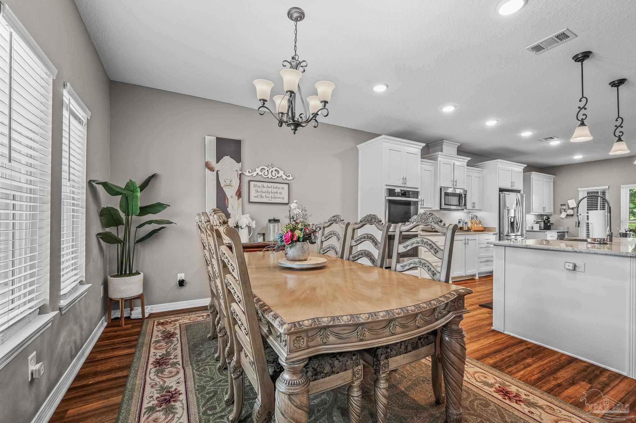 10443 Tam O Shanter Road Pensacola, FL 32514 - Photo 23 of 57 a view of a dining room with furniture and wooden floor