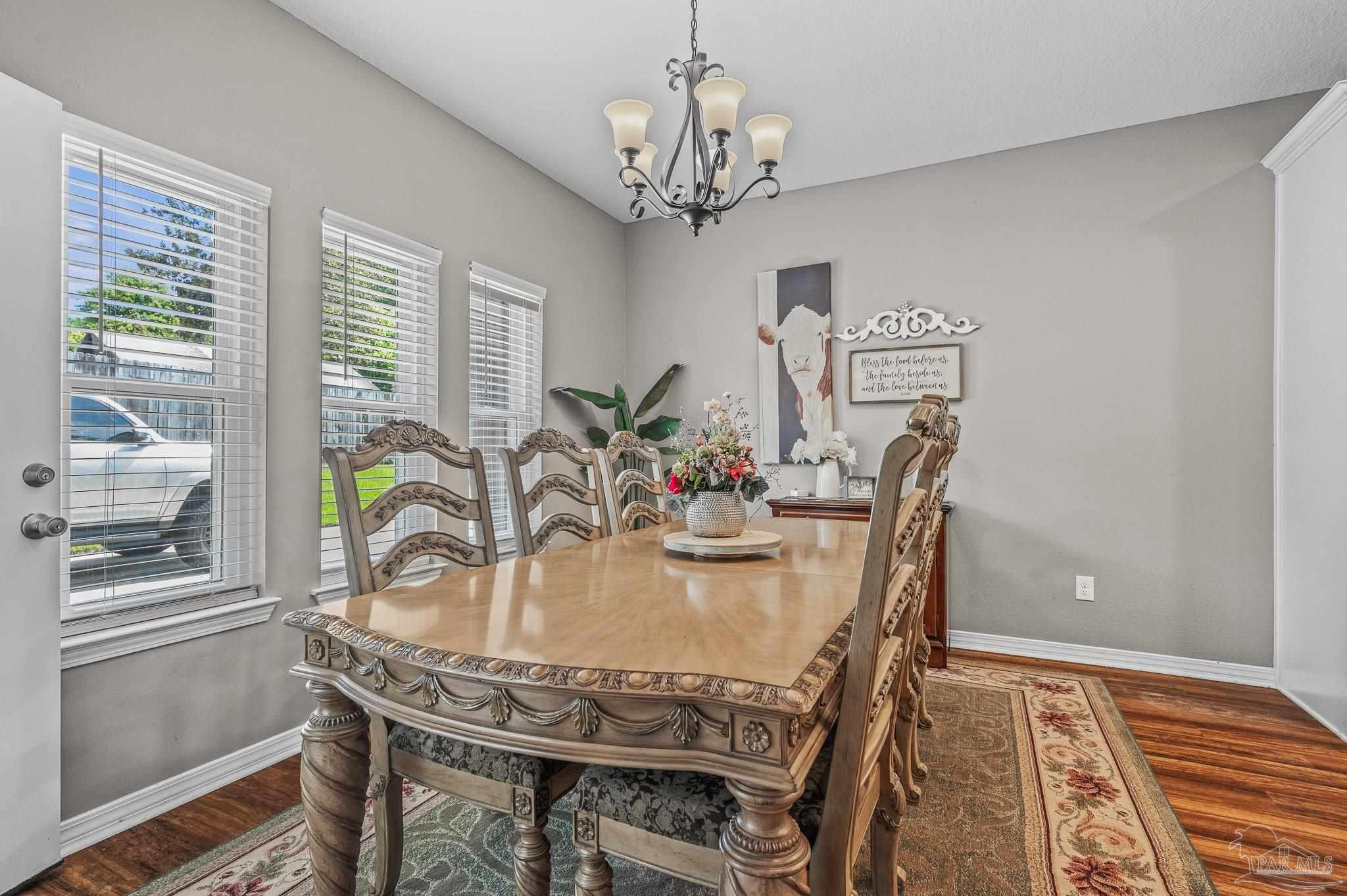 10443 Tam O Shanter Road Pensacola, FL 32514 - Photo 25 of 57 a dining room with furniture a rug and wooden floor