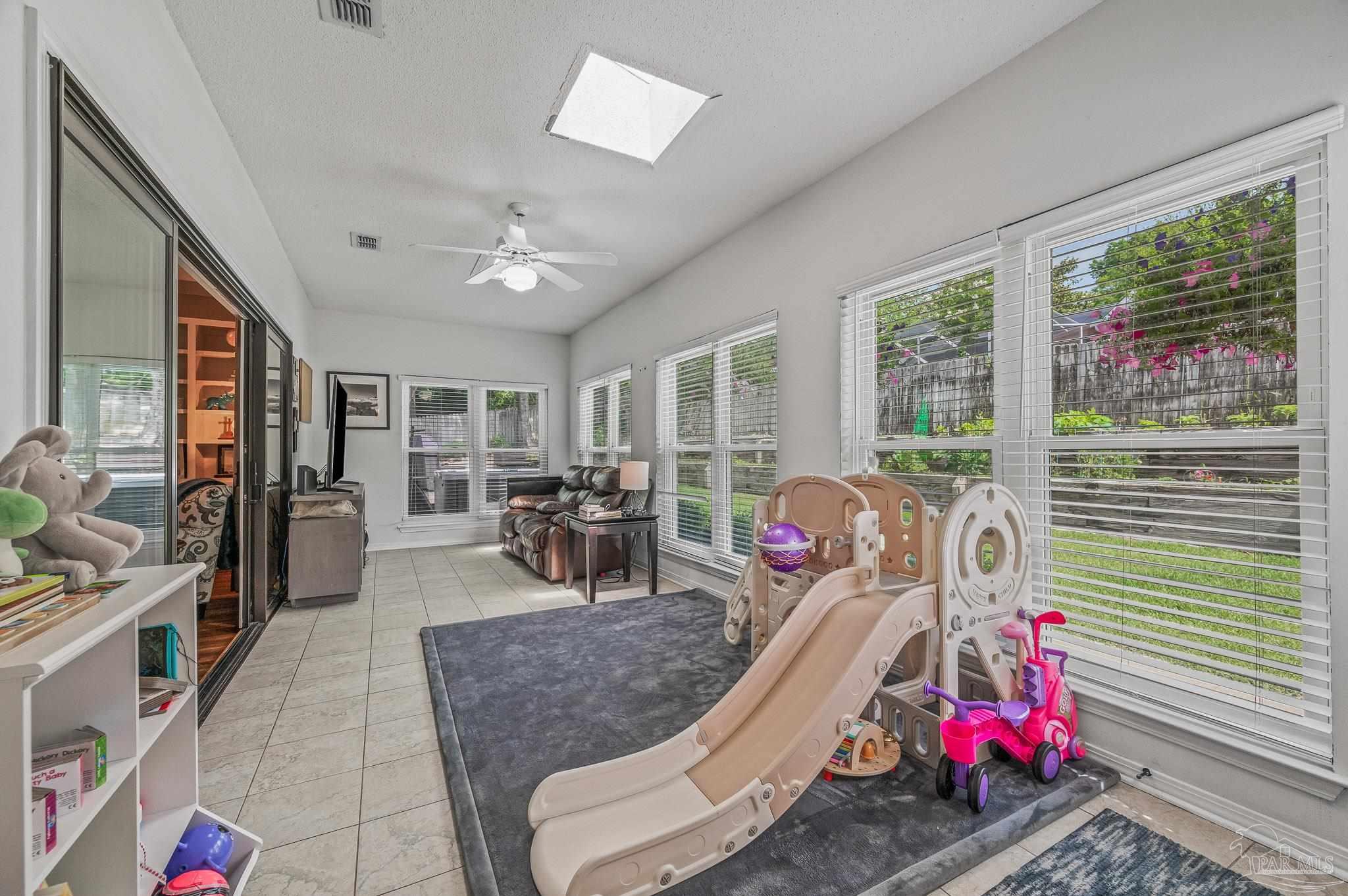 10443 Tam O Shanter Road Pensacola, FL 32514 - Photo 28 of 57 a bedroom with furniture and a floor to ceiling window