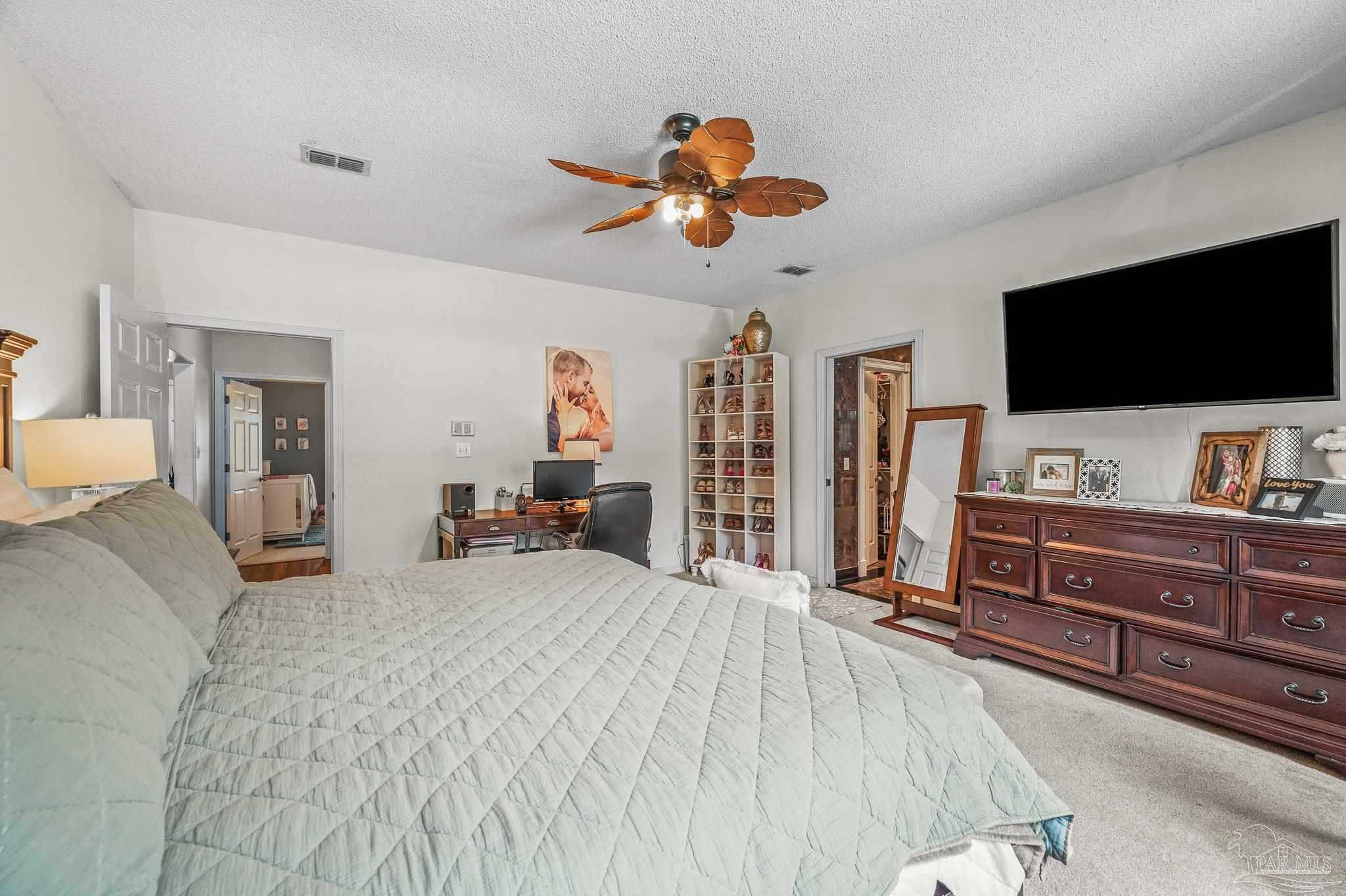 10443 Tam O Shanter Road Pensacola, FL 32514 - Photo 32 of 57 a bedroom with a bed and a flat screen tv