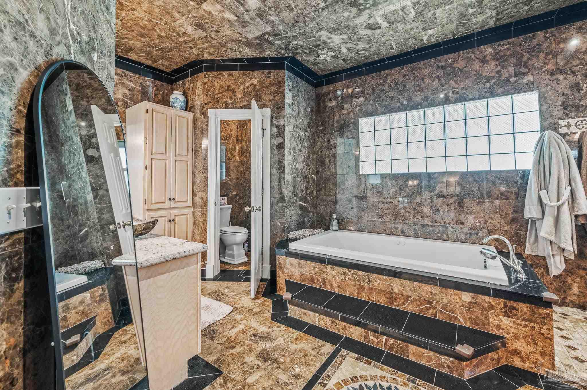 10443 Tam O Shanter Road Pensacola, FL 32514 - Photo 36 of 57 a bathroom with a bathtub and a shower