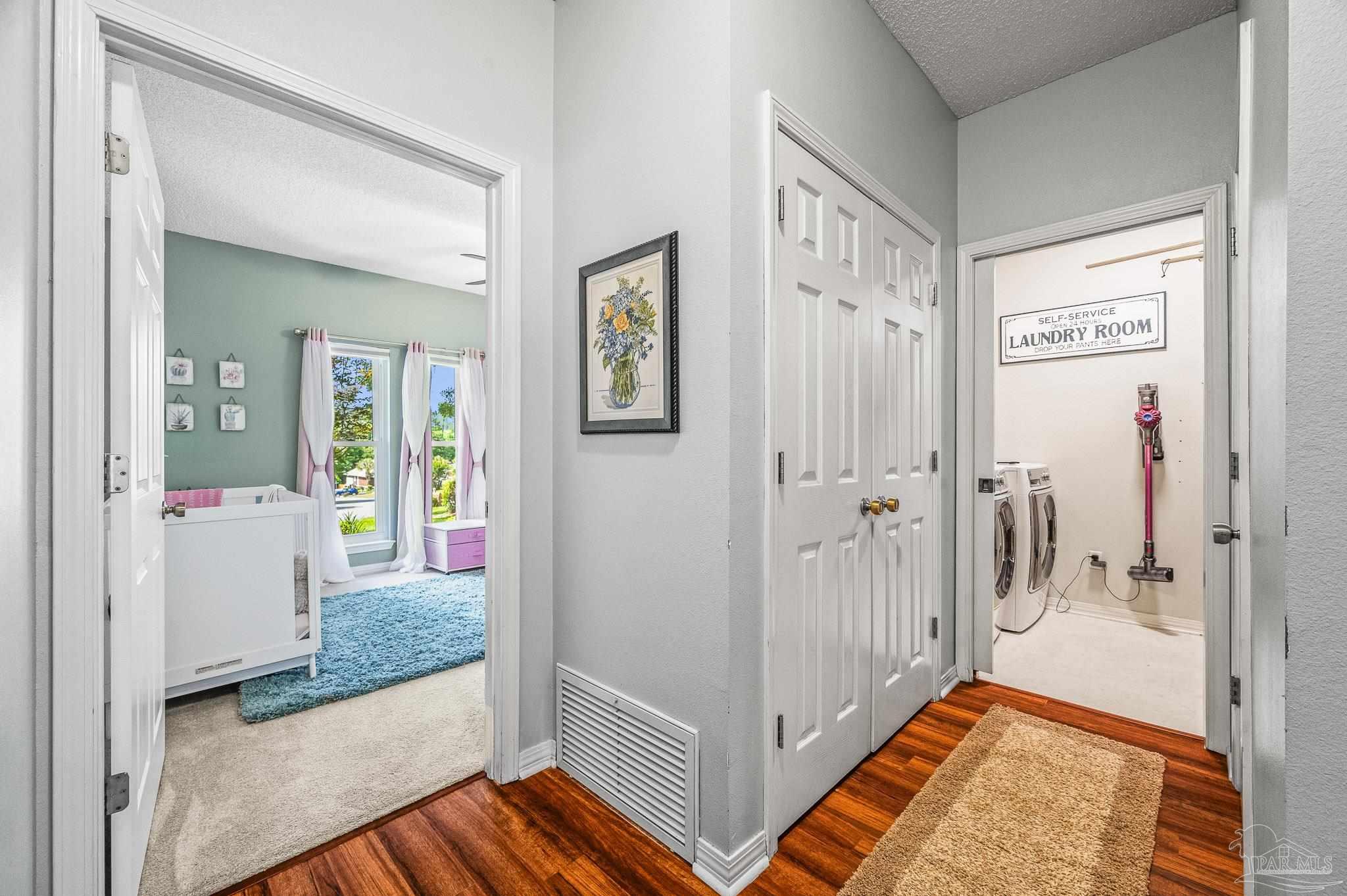 10443 Tam O Shanter Road Pensacola, FL 32514 - Photo 39 of 57 a view of a hallway with bathroom and wooden floor